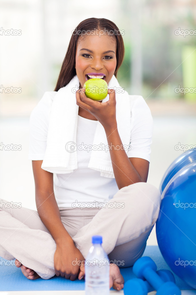 young african american woman eating apple